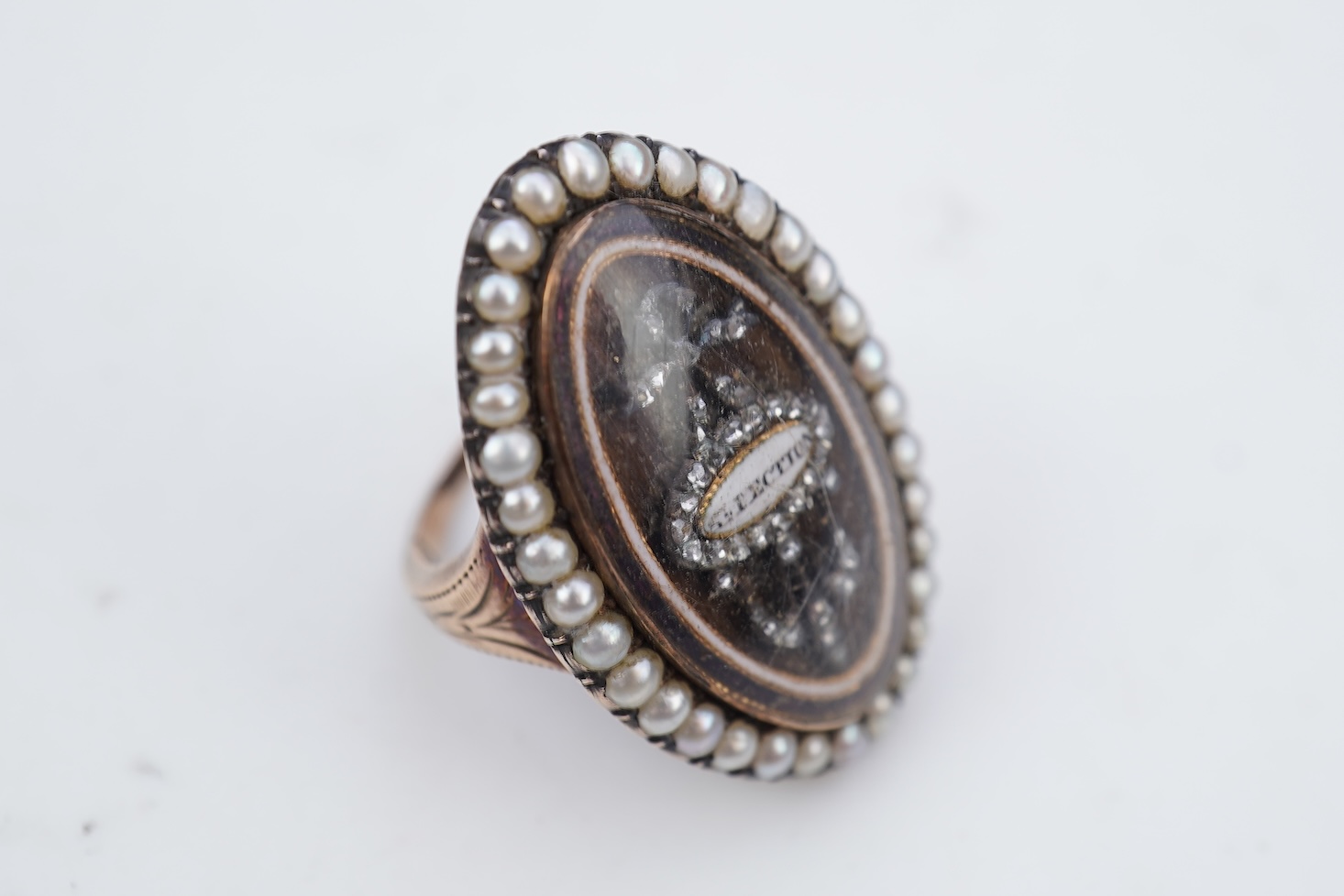 A fine George III seed pearl, enamel and diamond mourning ring, circa 1782